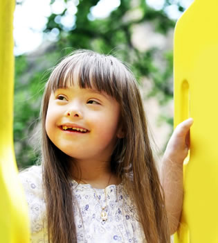 little girl on yellow slide